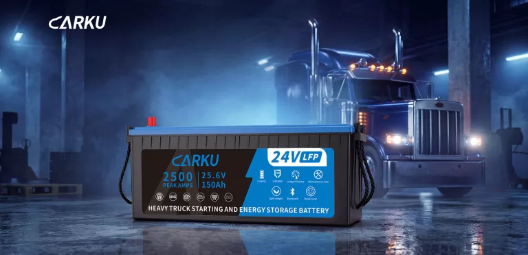 CARKU 24V LFP heavy truck starting battery in front of a semi-truck.